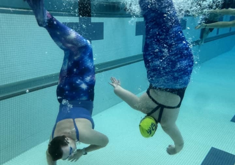 mermaid tails play in pool