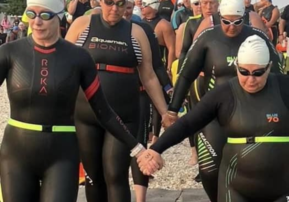 mermaids entering bridge swim hand in hand