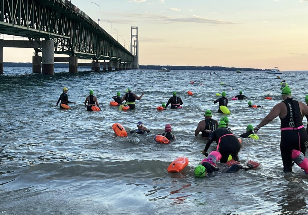 mermaids getting into water at bridge swim